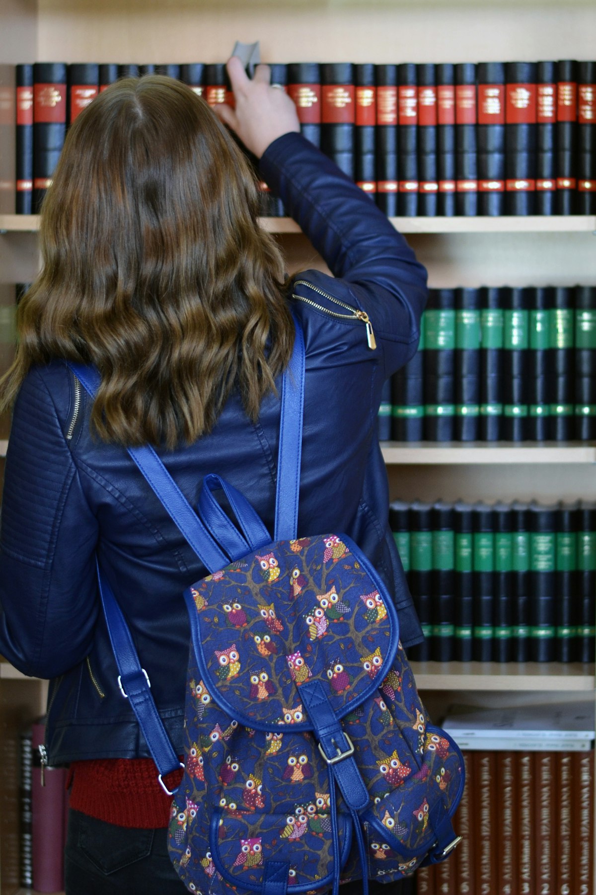 Estudiante consultando libros en la biblioteca